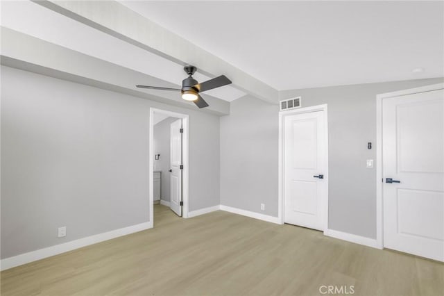 spare room with vaulted ceiling, ceiling fan, and light hardwood / wood-style flooring