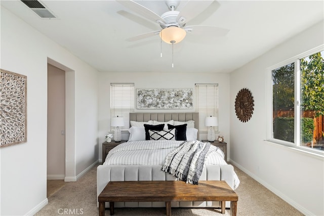 bedroom featuring light colored carpet and ceiling fan