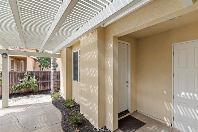 property entrance featuring a pergola