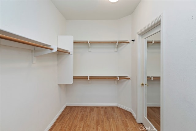 walk in closet featuring light hardwood / wood-style floors