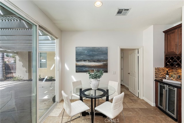 dining room with indoor bar and beverage cooler