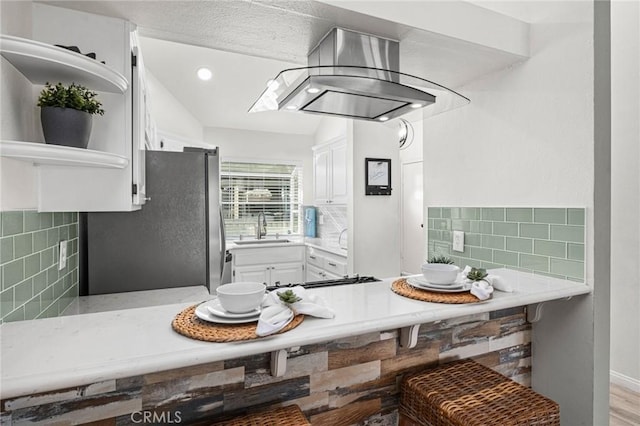 kitchen with sink, white cabinetry, and decorative backsplash