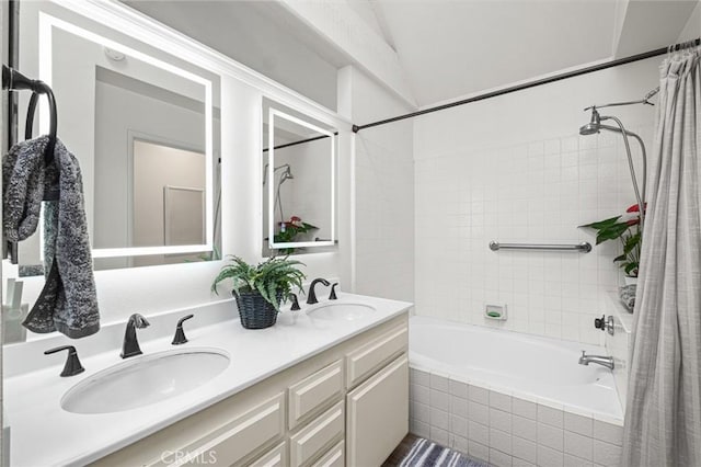 bathroom featuring vanity, shower / tub combo with curtain, and vaulted ceiling