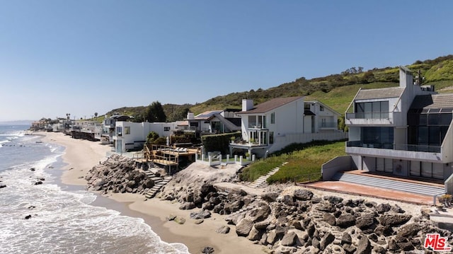 exterior space with a beach view and a water view