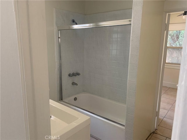 bathroom featuring shower / bath combination with glass door and tile patterned flooring