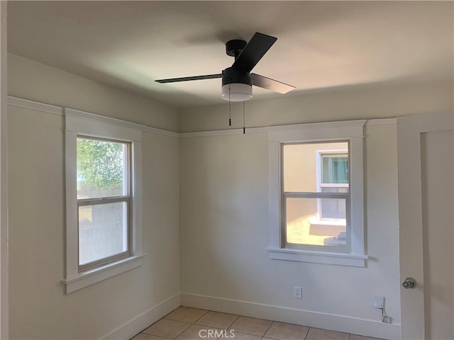 tiled empty room featuring ceiling fan