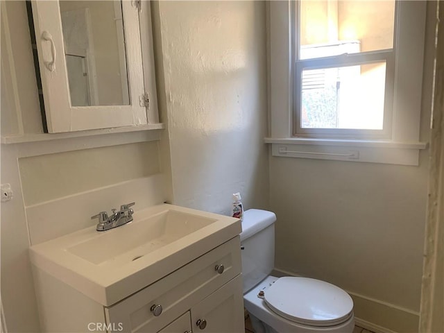 bathroom featuring toilet and vanity