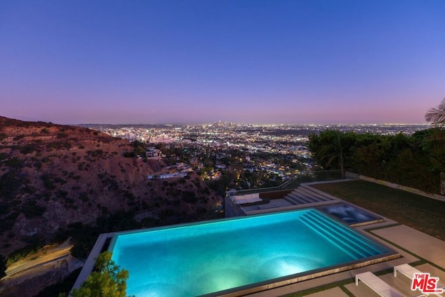 view of pool at dusk