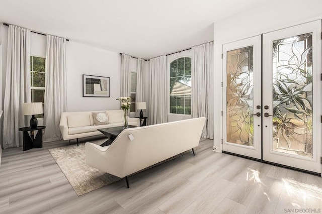 living room with light hardwood / wood-style flooring and french doors