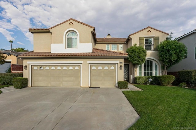 mediterranean / spanish-style home with a garage and a front yard