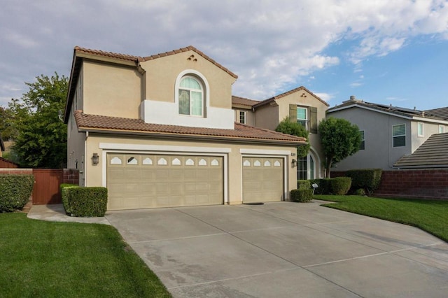 mediterranean / spanish house featuring a garage and a front yard