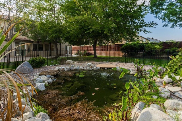 view of yard featuring a small pond