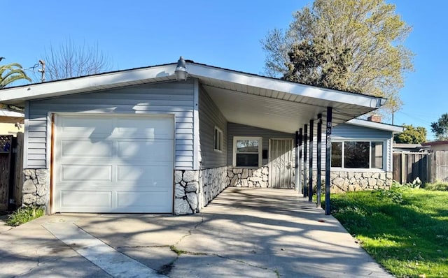 view of front facade with a carport, a garage, and a front lawn