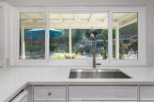 kitchen featuring sink and white cabinets