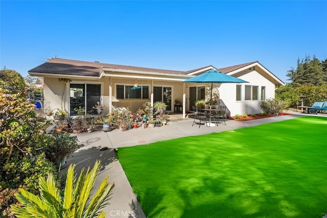 rear view of property featuring a yard