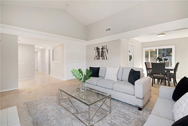 living room featuring light colored carpet and high vaulted ceiling