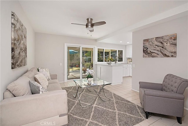 living room featuring light tile patterned floors and ceiling fan