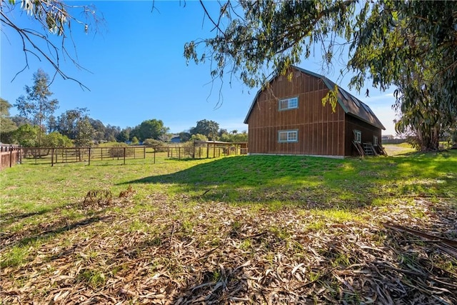 view of yard featuring an outdoor structure and a rural view