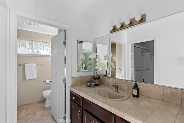 bathroom with tile patterned floors, toilet, and vanity