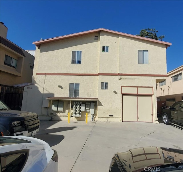 rear view of property featuring a garage