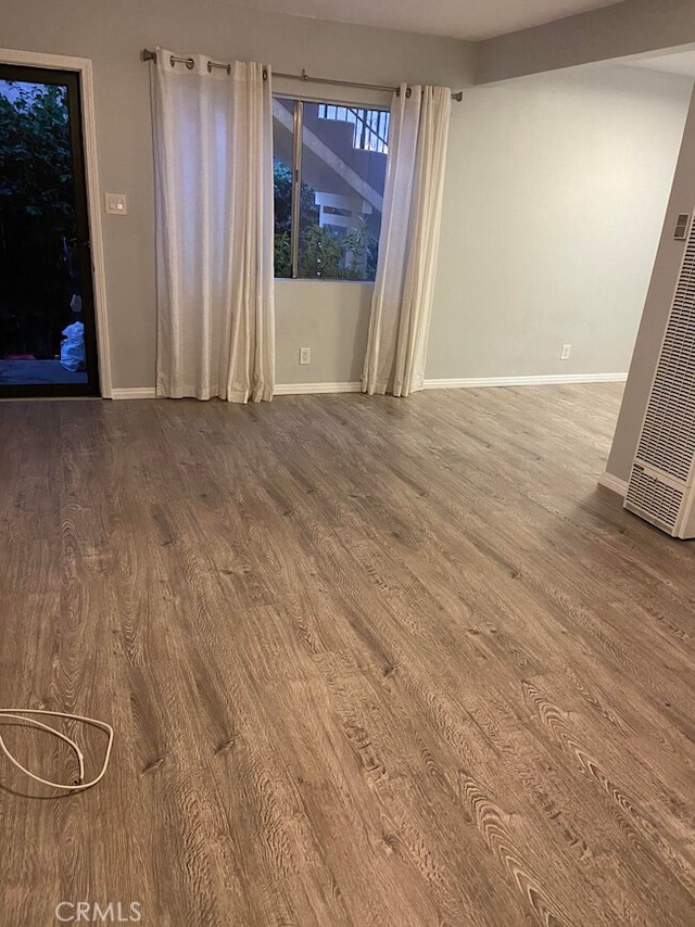 unfurnished room with wood-type flooring