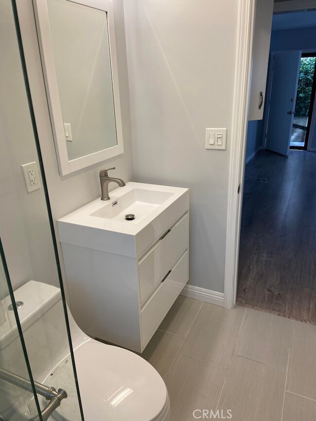 bathroom featuring vanity and toilet