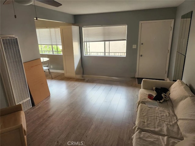 living room featuring light hardwood / wood-style floors and ceiling fan