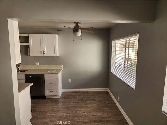 kitchen with sink, dishwasher, ceiling fan, white cabinetry, and dark hardwood / wood-style floors