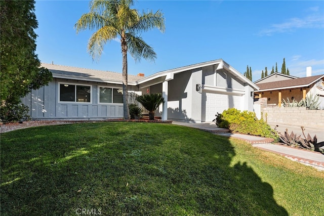 single story home with a garage and a front lawn