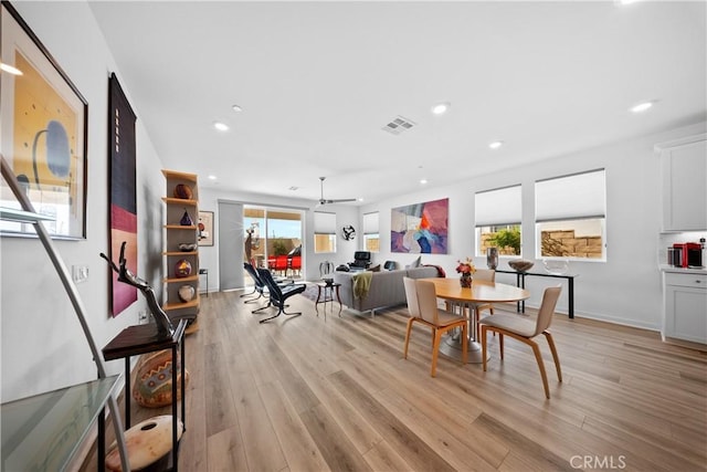 dining area featuring baseboards, light wood-style flooring, visible vents, and recessed lighting