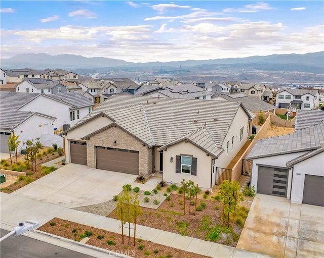 view of front of property featuring a garage and a mountain view