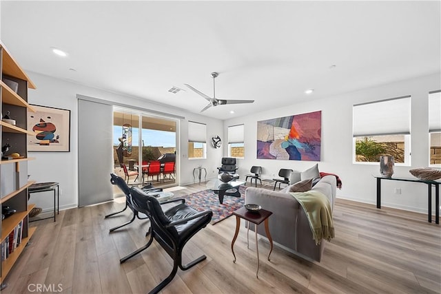 living room with recessed lighting, wood finished floors, a ceiling fan, baseboards, and visible vents