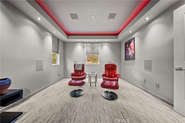 sitting room featuring a tray ceiling, baseboards, and recessed lighting