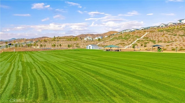 view of community featuring a gazebo, a lawn, and a mountain view