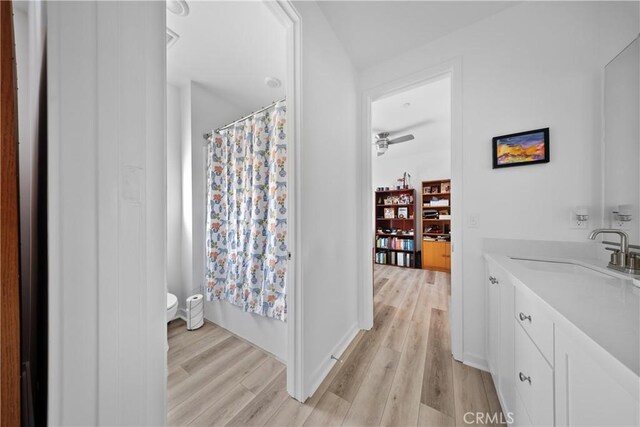 full bathroom featuring toilet, vanity, shower / bathtub combination with curtain, and hardwood / wood-style floors