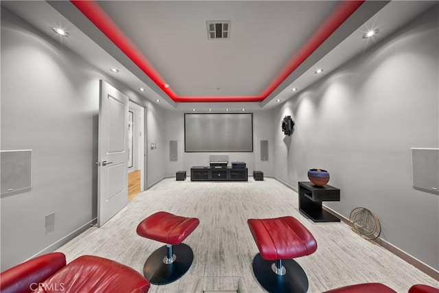 cinema room featuring a raised ceiling