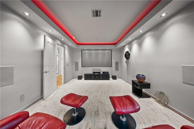 home theater featuring recessed lighting, a raised ceiling, visible vents, and baseboards