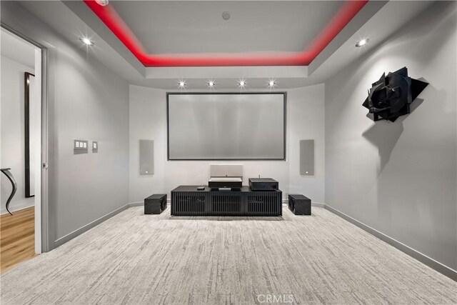 home theater room featuring a raised ceiling