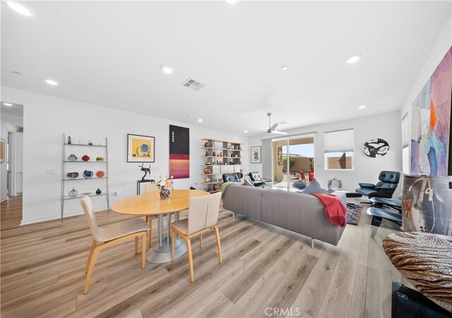 dining room with ceiling fan and light wood-type flooring