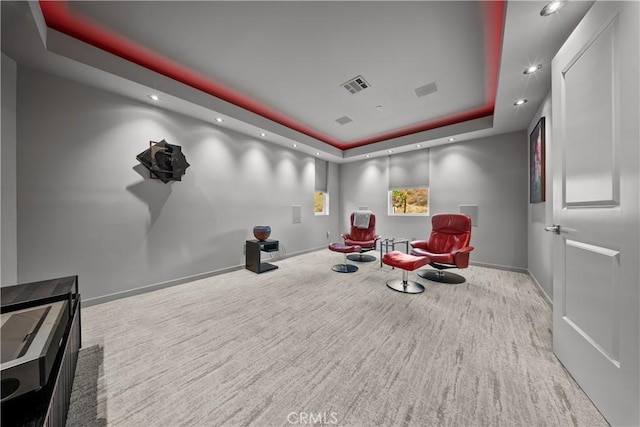 sitting room featuring carpet floors, a tray ceiling, recessed lighting, visible vents, and baseboards