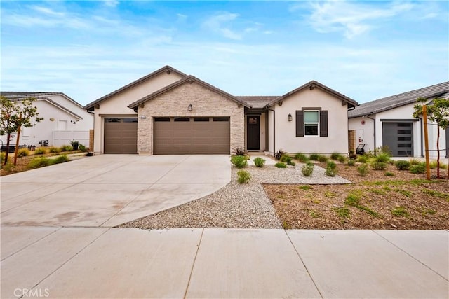 single story home with concrete driveway, an attached garage, and stucco siding