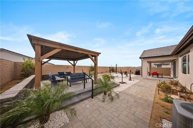 view of patio / terrace featuring an outdoor hangout area, a gazebo, central AC unit, and a fenced backyard