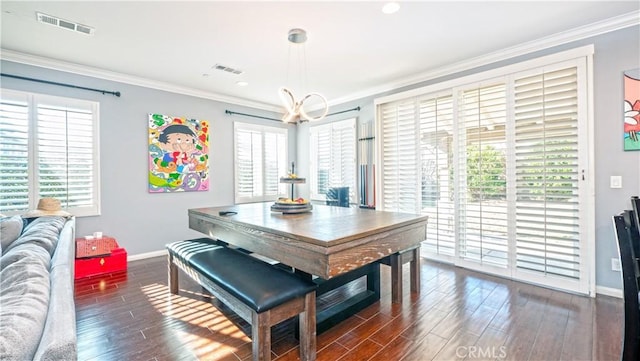 dining room featuring plenty of natural light, ornamental molding, and dark hardwood / wood-style floors