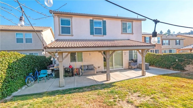 rear view of house with a yard and a patio