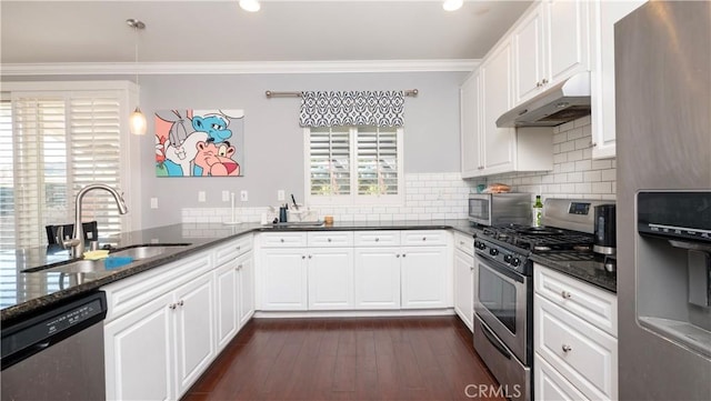 kitchen featuring sink, white cabinetry, dark stone counters, kitchen peninsula, and stainless steel appliances