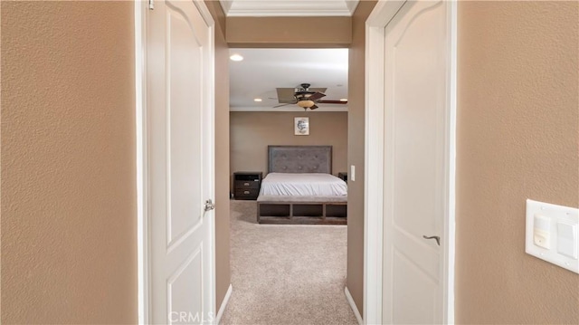 hallway featuring crown molding and carpet