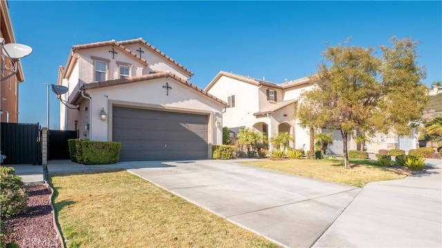 mediterranean / spanish-style house with a garage and a front lawn