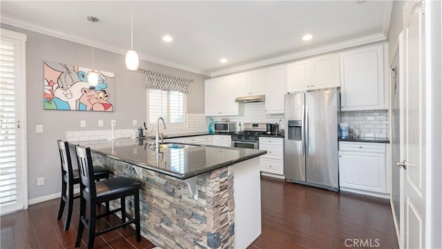 kitchen featuring stainless steel appliances, kitchen peninsula, sink, and white cabinets