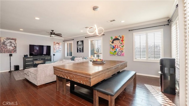 dining room with crown molding and ceiling fan