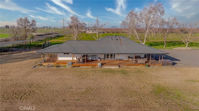 back of property featuring a rural view